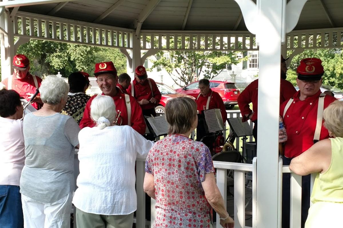 Providence Brigade Band Members Meet with Guests During a Break at the Summer Concert