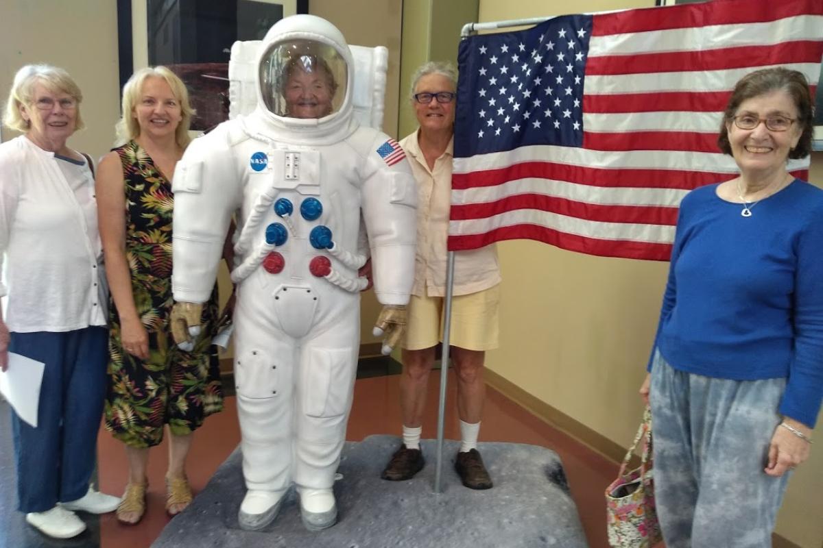 Four Adventurers Pose with the Astronaut at the McAuliffe-Shepard Discovery Center