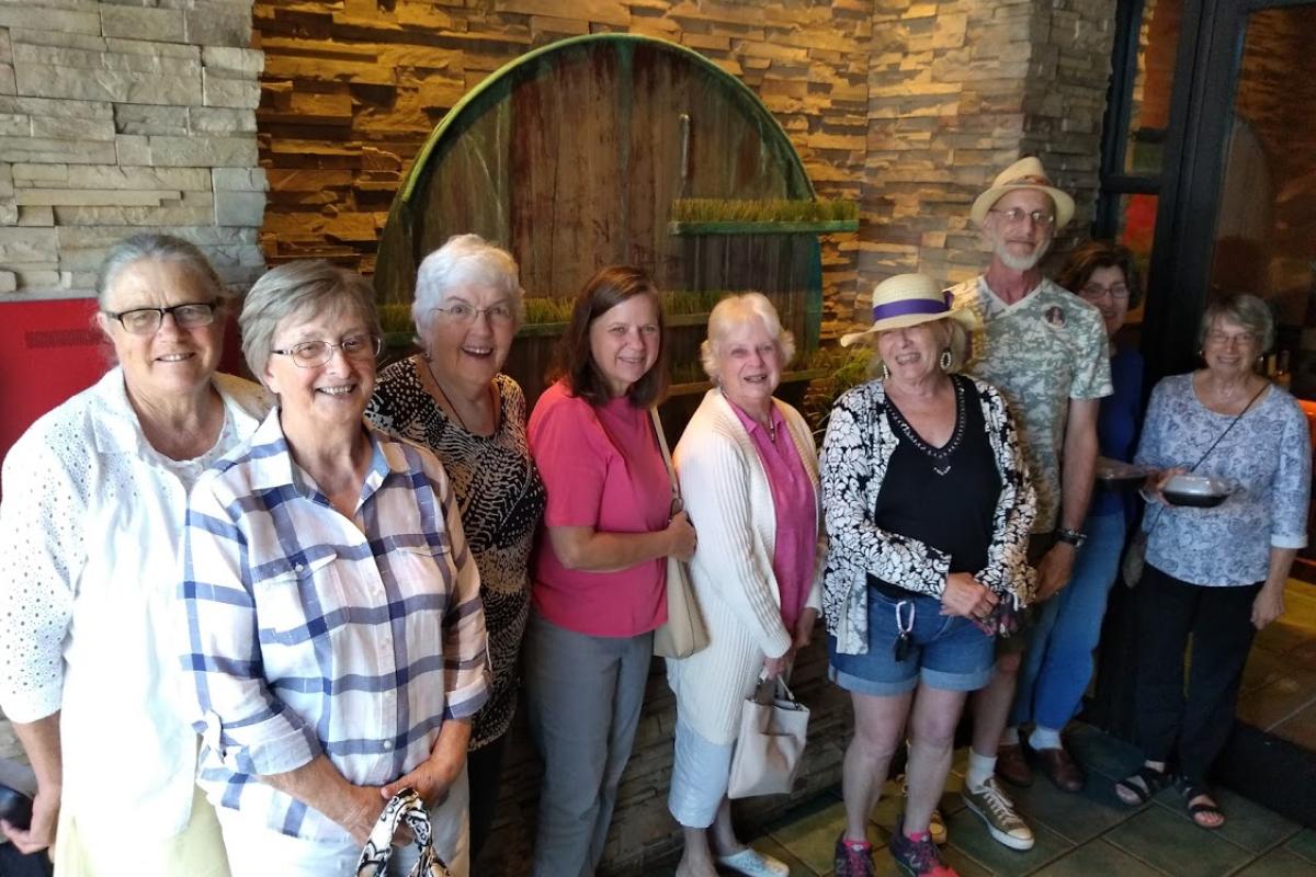 Several Guests Pose in Lobby of Seasons 52 Restaurant