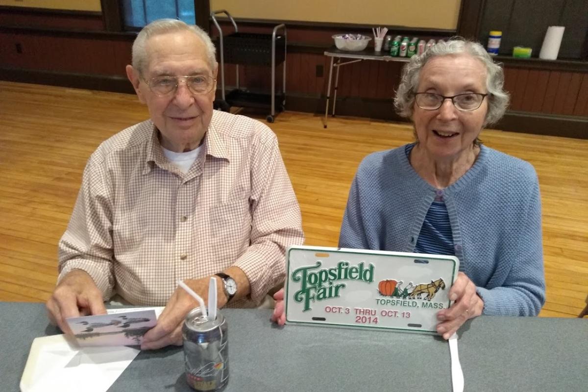 A Couple Holds Up a Topsfield Fair License Plate 