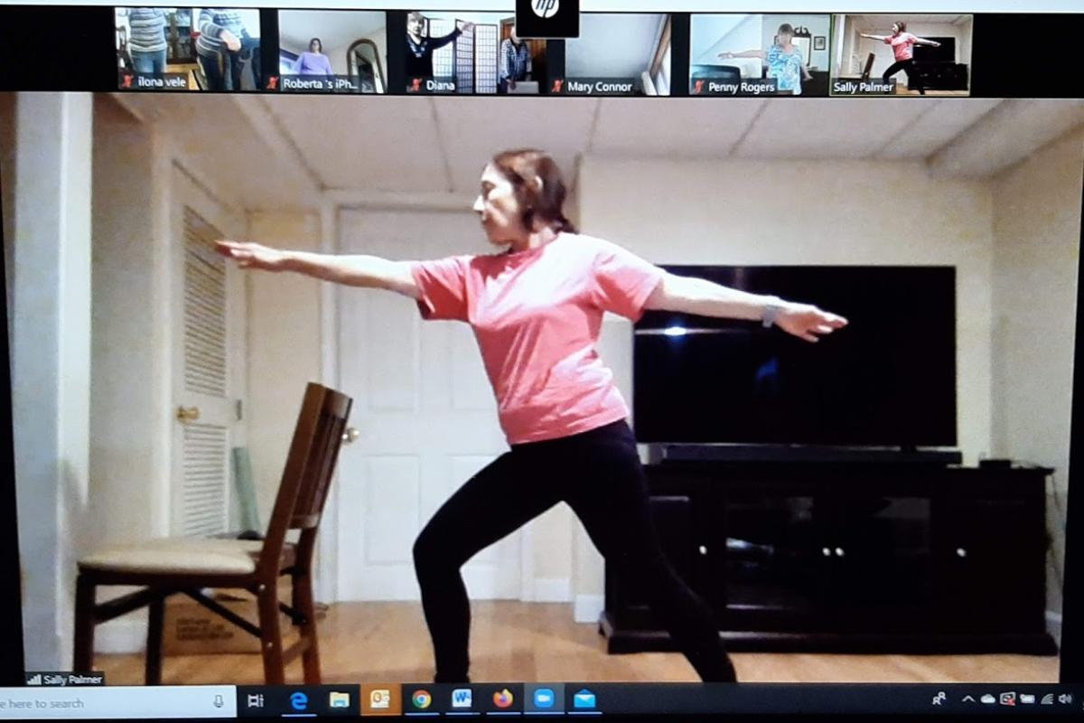 Yoga instructor teaches class virtually