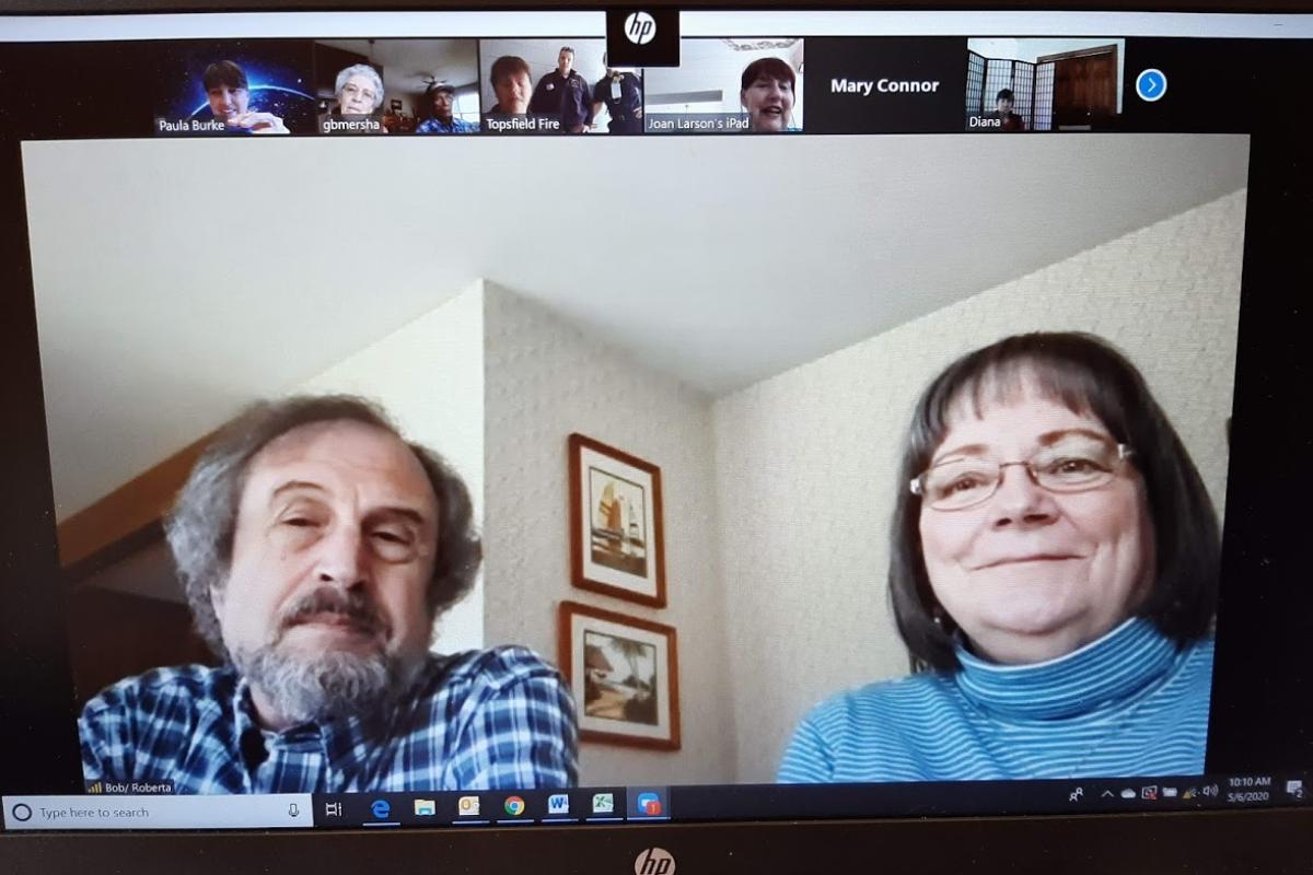 Man and woman participate in a Zoom meeting