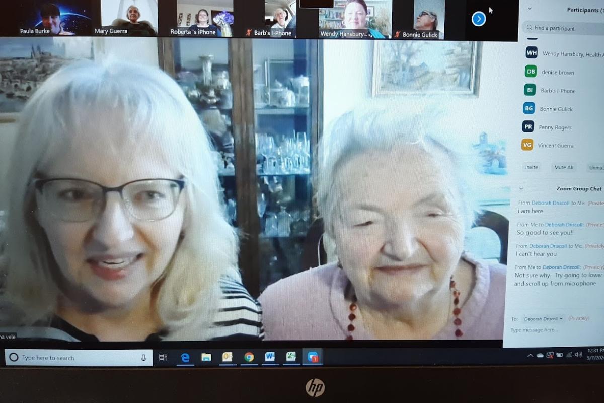 Two women participate in Zoom meeting