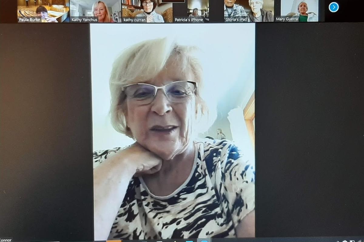 Woman participates in Zoom meeting