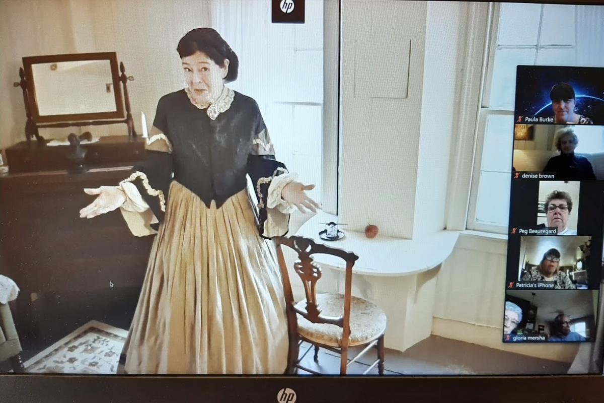 Woman dressed up in period clothing shared on Zoom screen