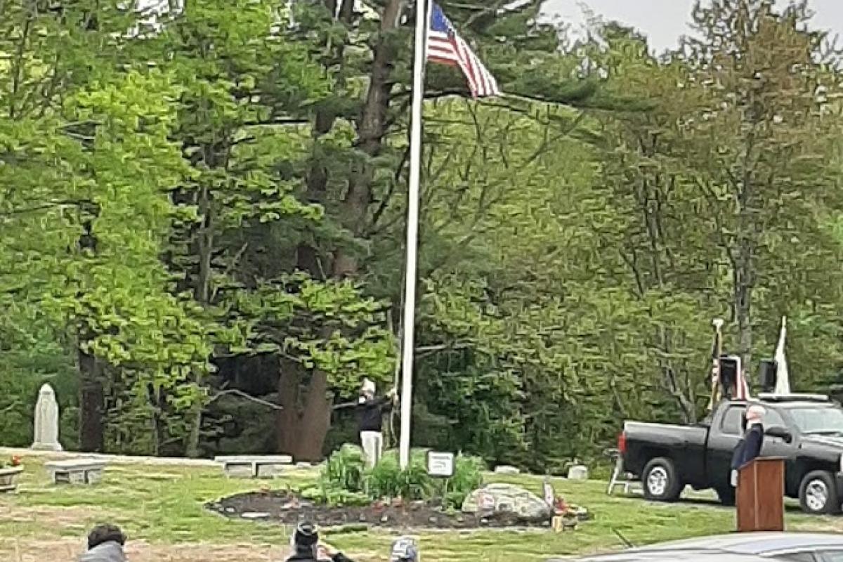 Flag raising at cemetery