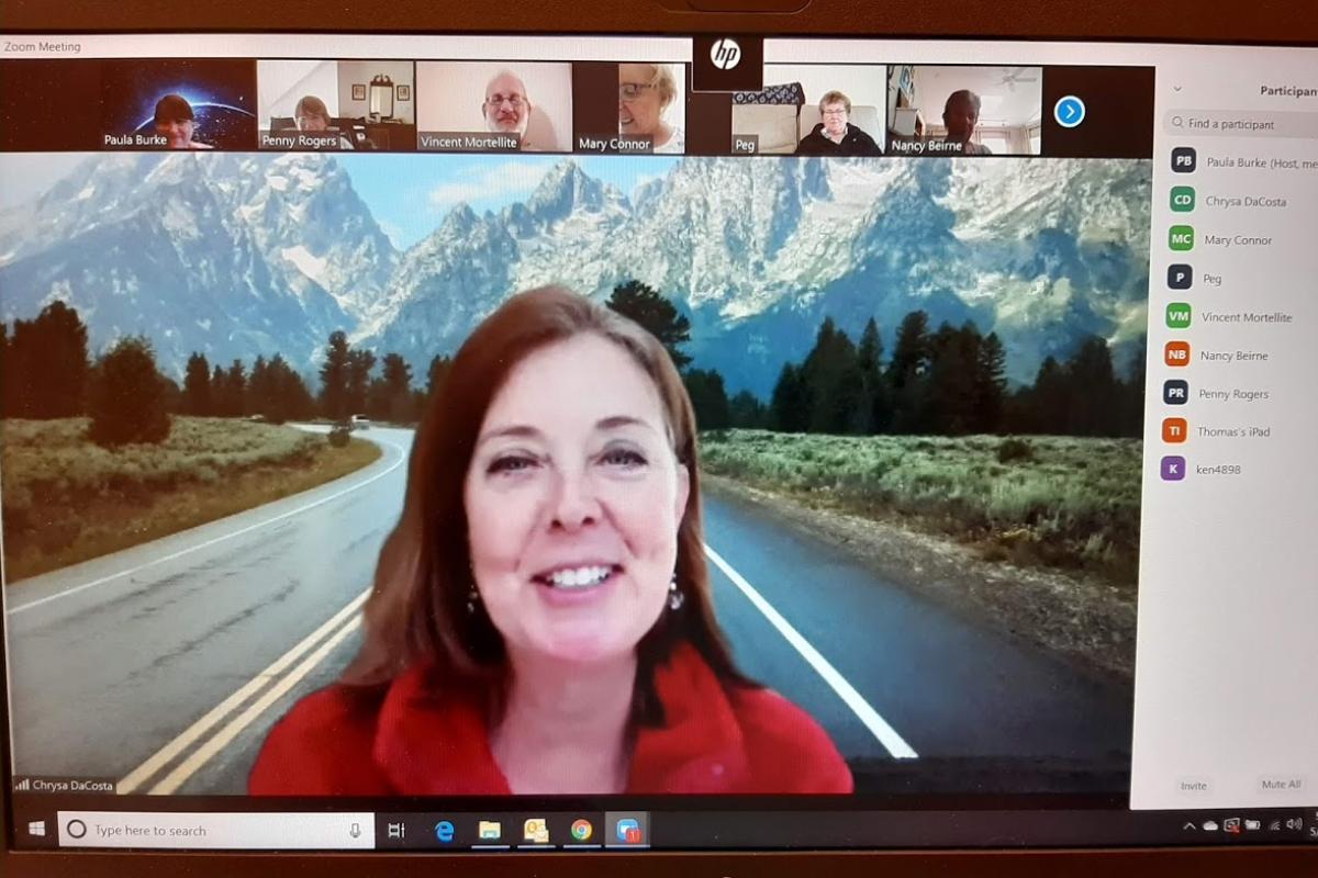 Zoom meeting host shown with mountains in background