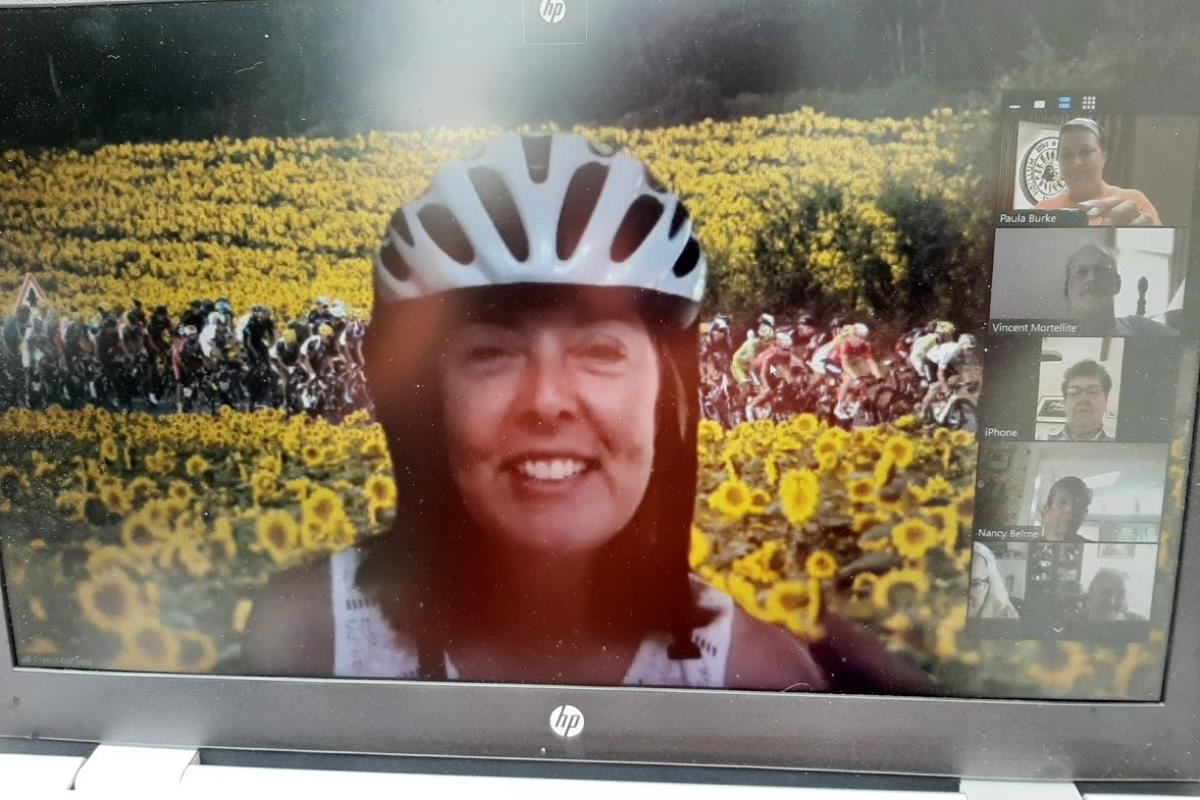 Zoom meeting speaker view woman in bike helmet