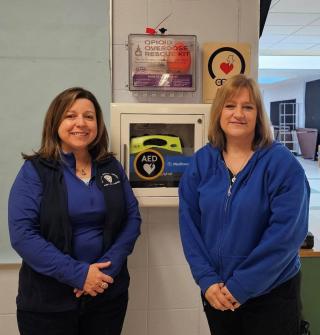 Nurses in front of Narcan Box